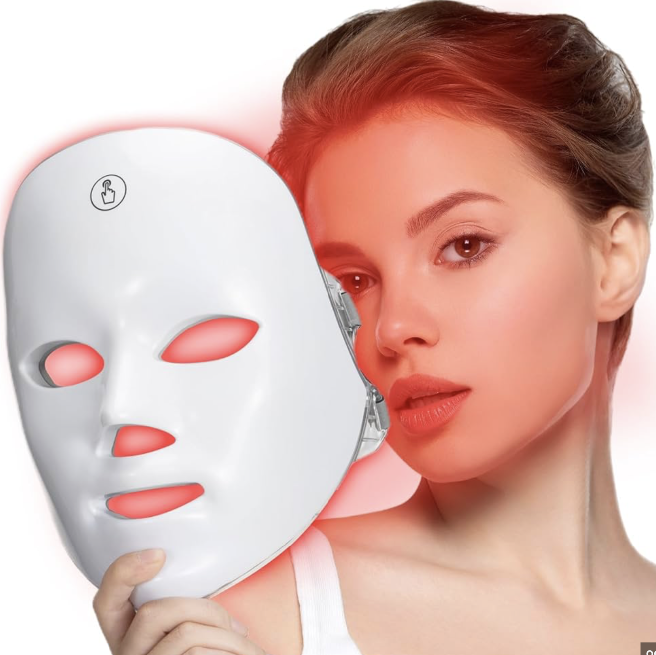 Woman holding the LUMÉ LED red light therapy mask, skin glowing warm
